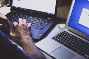 A PC and Mac next to each other on a desk